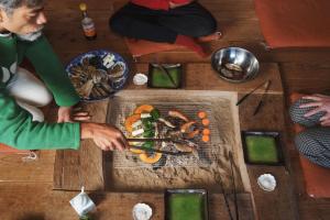 a group of people sitting around a table with food at 竜野園藝 in Kamimashiki +16 photos