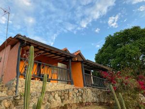 a house on a hill with a stone wall at Cabañas Cañon Del Chicamocha in Aratoca