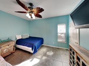 - une chambre dotée d'un ventilateur de plafond et d'un mur bleu dans l'établissement Motor Boat Inn, à Île Padre