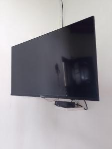 a flat screen tv hanging on a wall at Cabañas "Las Acacias" in Villa Santa Cruz del Lago