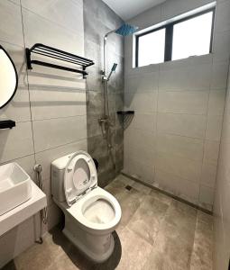 a bathroom with a toilet and a sink and a shower at Lodge 43 House in George Town