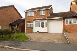 a brick house with a white garage at *3Bed House Central location Free Parking Perfect for contractors & groups Managed by Chique Properties Ltd in Great Linford