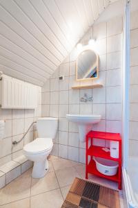 a bathroom with a toilet and a sink at Dom Gościnny Ewa in Rewal