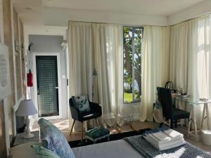 a living room with a bed and a table and chairs at A Villa by the Sea Bed & Breakfast in Vila Franca do Campo
