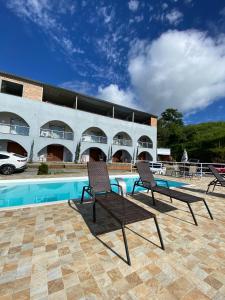 a group of chairs sitting next to a swimming pool at Recanto Filadélfia in Paraty