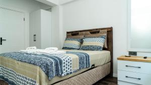 Schlafzimmer mit einem Bett mit blauer und weißer Bettwäsche in der Unterkunft Port Marmaris Rooms in Marmaris