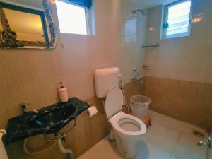 a bathroom with a toilet and a sink at Piller homes 3 BHK Pune in Pune