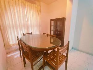 a dining room table with two chairs and a wooden table at Piller homes 3 BHK Pune in Pune