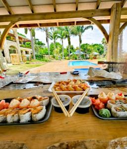 a table topped with trays of food and sushi at Lagoon Breeze Guest House in Knysna