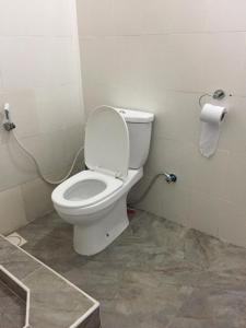 a bathroom with a toilet and a roll of toilet paper at Gabibo Kendwa Beach House in Kendwa