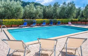 a swimming pool with lounge chairs and a pool at Gorgeous Home In Ascoli Piceno With Wifi in Ascoli Piceno