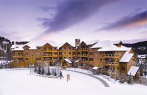 a large building in the snow with snow at Mountain Thunder Lodge in Breckenridge