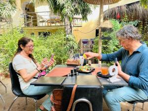 a man and a woman sitting at a table at IL Padrino hotel in Pushkar