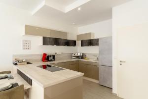 a kitchen with white cabinets and a counter top at Bodensee Loft - 116 m² Traumwohnung in Uhldingen-Mühlhofen