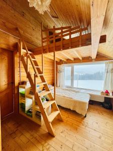 a bedroom with a bunk bed and a staircase in a room at Kam In in Krivopolʼye