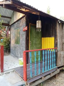 a small house with a colorful front door at peaceland farmstay in Ban Mai (1)
