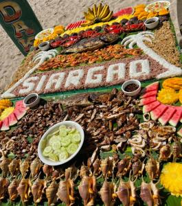 a table with many different types of insects on it at Siargao Zita's Garden Inn in General Luna