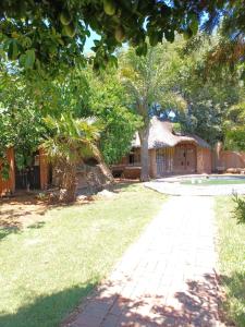 a yard with a house and a brick driveway at Shalom guesthouse in Bloemfontein