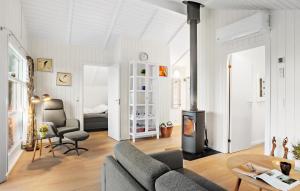 a living room with a couch and a fireplace at Holiday Home Solbjergvej Sydals Denm in Høruphav