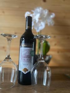 a bottle of wine and two glasses on a table at The Sandy Pod in Stornoway