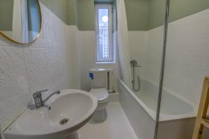 a bathroom with a sink and a toilet and a shower at Quite apartment in Bishkek