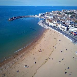 an aerial view of a beach with people in the water at Silk Accommodation in Margate
