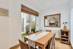 a dining room with a table and a mirror at Gem on the Rye in London