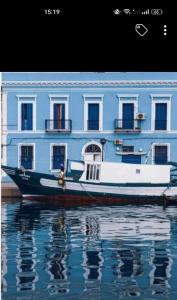 a boat sitting in the water in front of a building at Vieux-Port in Bizerte