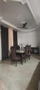 a dining room with a table and chairs at Luxe Ganga view Villa with Terrace Seating (Vacaow) in Rishīkesh