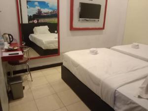 Postel nebo postele na pokoji v ubytování Dya Hotel Boyolali