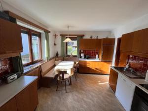 a kitchen with a table and a dining room at Ferienhaus Heimatplatzle in Oetz