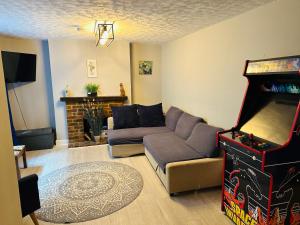 a living room with a couch and a video game at Newly refurbished - Near seafront - Retro games machine - Central Brighton - 1 bedroom apartment in Brighton & Hove