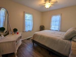 a bedroom with a bed and a dresser and a mirror at Peaceful Family Lake House in Hawthorne