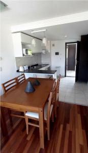 a kitchen and dining room with a wooden table and chairs at Duplex Quinta Luna in San Carlos de Bariloche