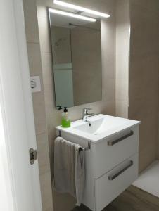 a bathroom with a white sink and a mirror at Casa Blanca in Oliva