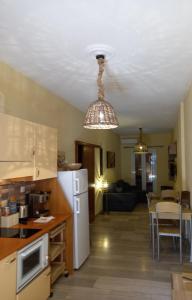 a kitchen and living room with a white refrigerator at Helens Apartment in Tolo