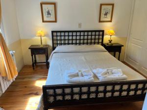 a bedroom with a bed with towels on it at "La Loma" - Vieja Casona in El Calafate