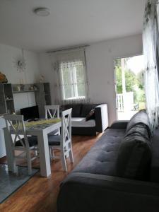 a living room with a couch and a table at Apartman Mila in Ostrovo