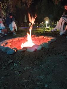 a fire pit in a park at night at Riad Sidi Hicham in Marrakesh