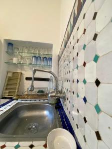 a small bathroom with a sink and a toilet at Dar Coeur De Tanger - Riad Privé avec terrasse in Tangier