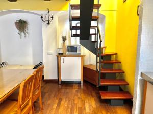 プラハにあるOld Town Prague Apartmentのダイニングテーブルとらせん階段が備わる客室です。