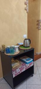 a table with a tea kettle on top of it at Natura Affittacamere in Campobasso +18 photos