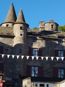 an old castle with turrets on top of a building at La Roulotte romantique des volcans in Saint-Saturnin