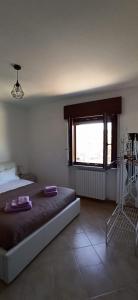 a bedroom with a large bed and a window at Natura Affittacamere in Campobasso