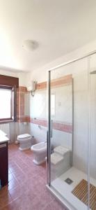 a bathroom with two toilets and a shower at Natura Affittacamere in Campobasso