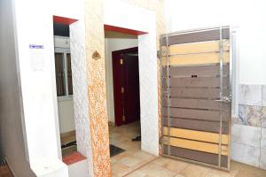 a hallway with a glass door in a room at Akash Avenue Soniya Service Apartment in Tirunelveli