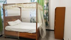 Bett mit Baldachin in einem Zimmer in der Unterkunft Amour Kendwa Beach House in Kendwa
