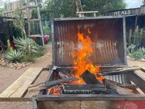 a fire in a container with flames in it at Vu Glamping in Hue