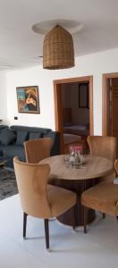 a dining room with a wooden table and chairs at BRIECH HOUSE in Asilah