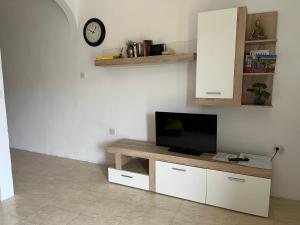a living room with a flat screen tv on a table at Gozo Belle Mare Apartments in Marsalforn